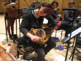 Clare Salaman tunes the hurdy gurdy